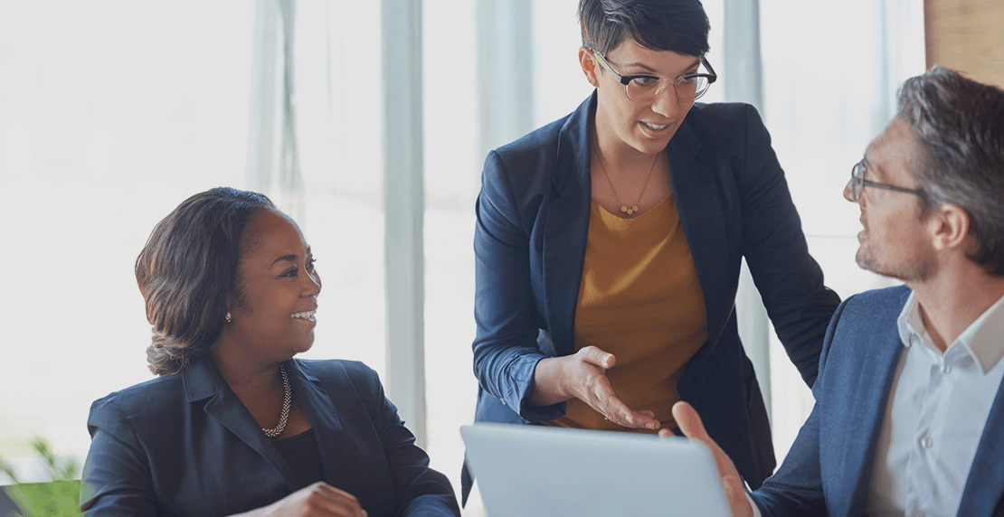magna-health-plan Group of three business people meeting around laptop