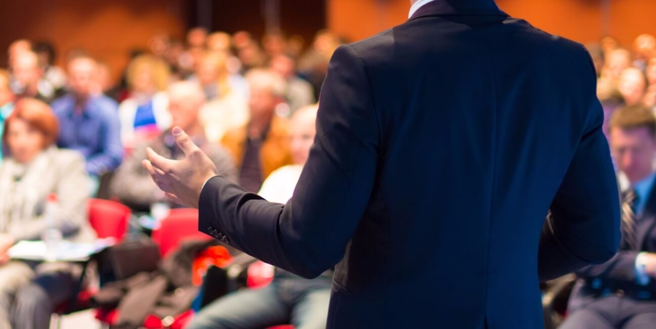 20160217205210-speaker-public-presentations-audience-conference-hand-gestures-body-language-information-meeting-talking-2 Person giving speech to large group of people