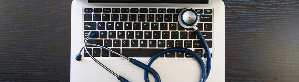 Stethoscope in doctors desk Stethoscope placed on laptop